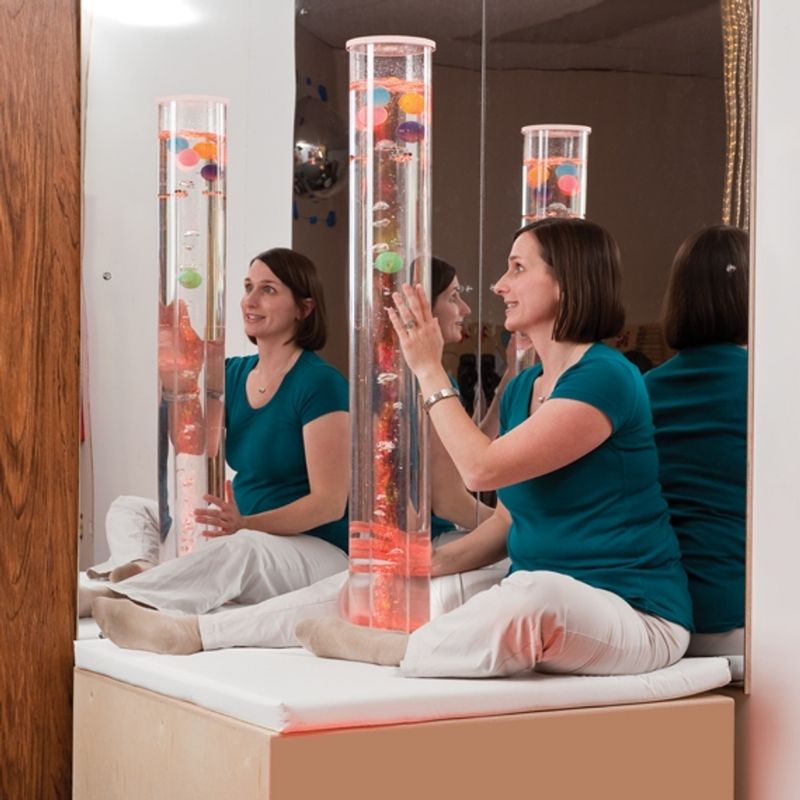 SouthpawBubbleTubewithPingPongBallInsertandPaddedPlatform-woman in touching the tube un indoor set up