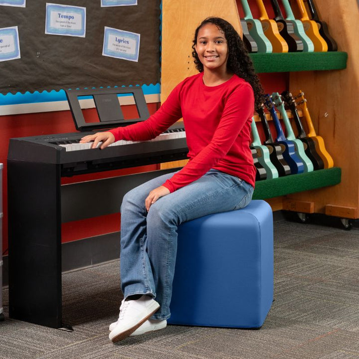 Jaxx Monroe 18in foam ottoman in blue vinyl, used as classroom seating in a music room