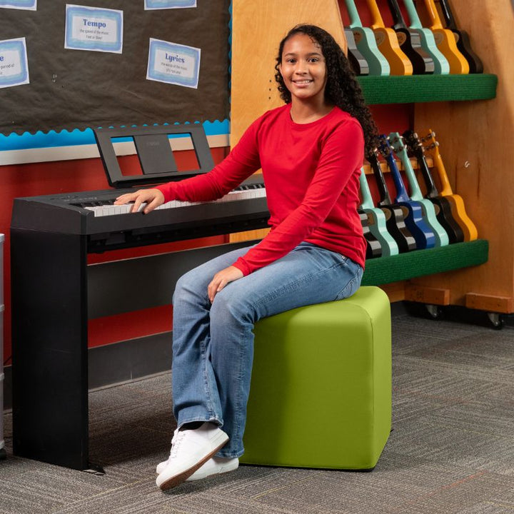 Jaxx Monroe 18in foam ottoman in green vinyl, used as classroom seating in a music room