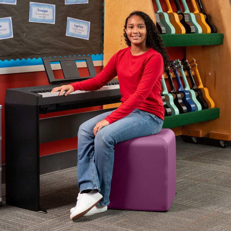 Jaxx Monroe 18in foam ottoman in purple vinyl, used as classroom seating in a music room