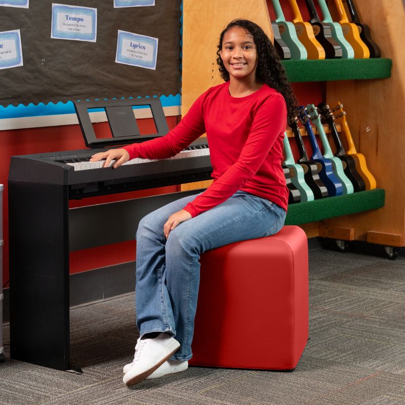 Jaxx Monroe 18in foam ottoman in red vinyl, used as classroom seating in a music room
