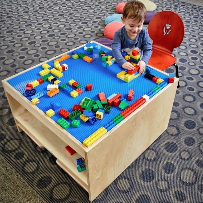 3branch Discovery Table Mini with two reversible activity tops providing four distinct play surfaces for building blocks, train tracks, pegboard, and open work activities