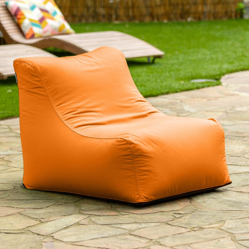 Jaxx Ponce Outdoor Bean Bag Chair in Sunbrella Tangerine on a flagstone patio, a bright orange poolside bean bag chair