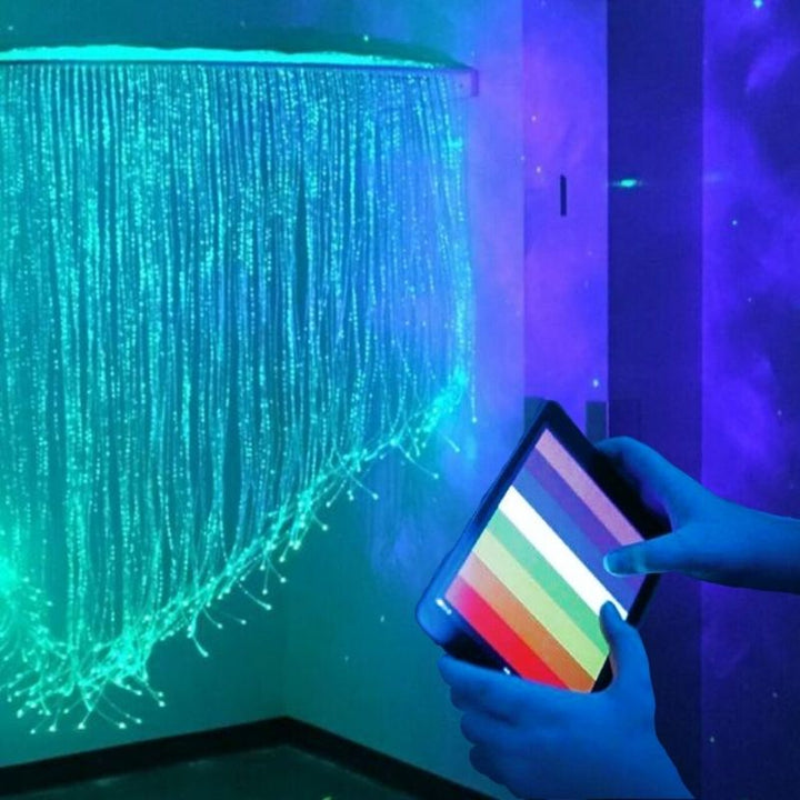 TFH Genie Quarter Circle Fiber Optic Curtain -  Corner room view with color controler on hand
