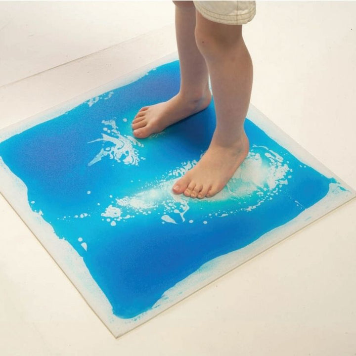 TFH Large Square Liquid Floor Tiles - 4 Set - Toddler stepping on blue tile