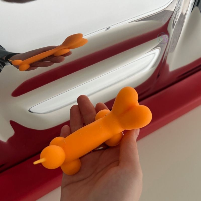 TFH Sensory Mirror With Padded Frame - Close up view with hand holding an orange balloon