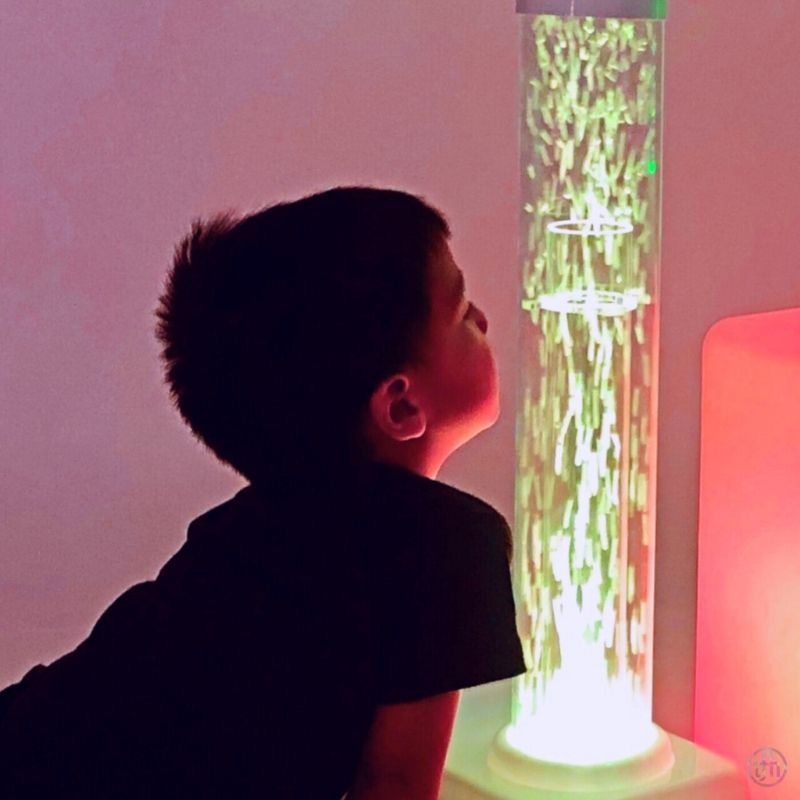 TFH Tabletop Hurricane Tube - Waterless - Child active play staring at tube vack view