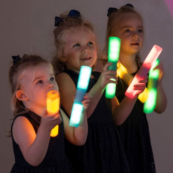 TTS Light Up Glow Cylinders - Three Girls Holding Cylinders
