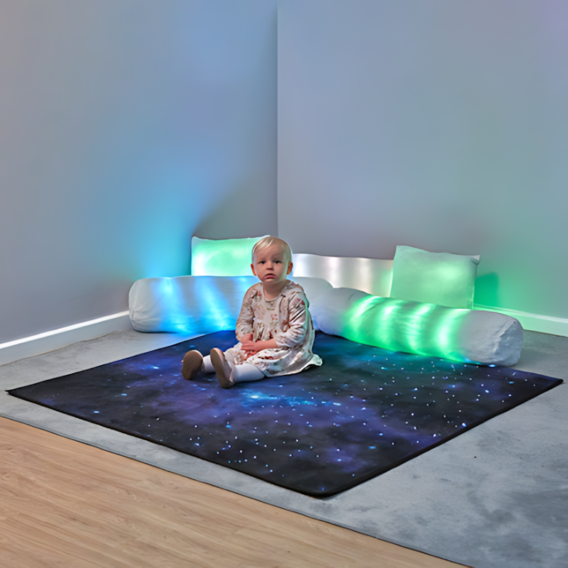 TTS Rechargeable Fibre Optic Sparkle Rug Child Sitting Greenish Blue Background