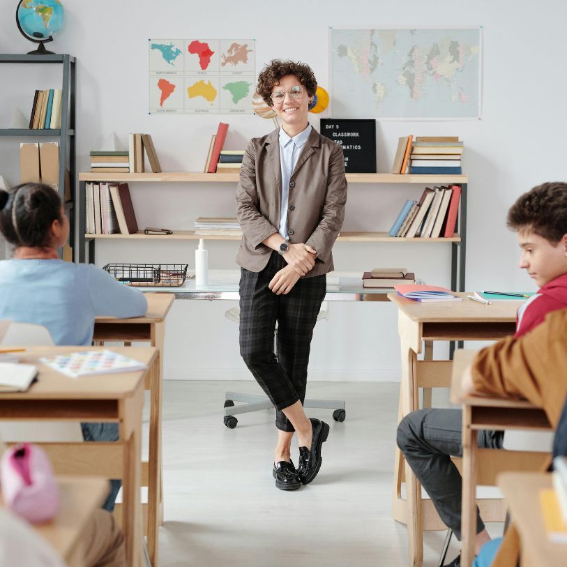 Teacher standing ahead of class