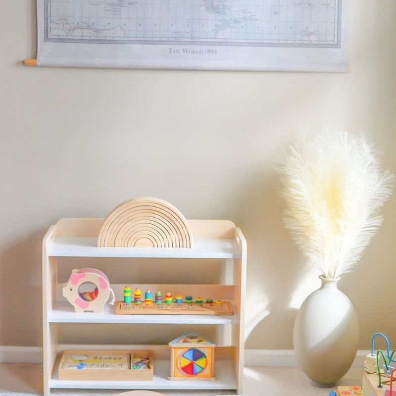 Sapiens Child Banana Montessori Shelf with Borders front view in an indoor home setting, showing the compact Canadian-made child-sized toy shelf with open design and eco-friendly wood finish