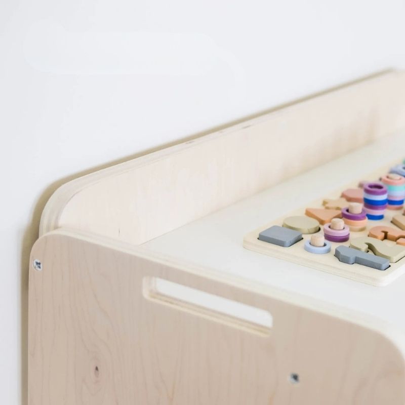 Banana Montessori Shelf with Borders top corner detail view showing the rounded edges, raised border height, and eco-friendly non-toxic wood finish of the Canadian-made Montessori shelf