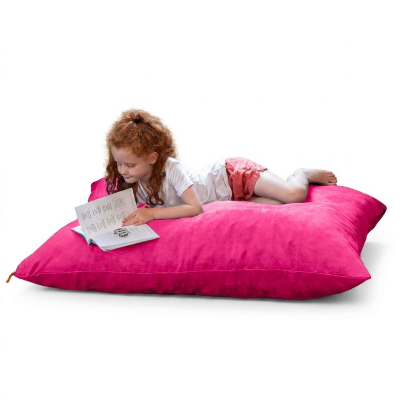 Child reading on a Jaxx Pillow Saxx 4 bean bag floor pillow in Fuchsia microsuede, a colourful kids floor pillow for playrooms