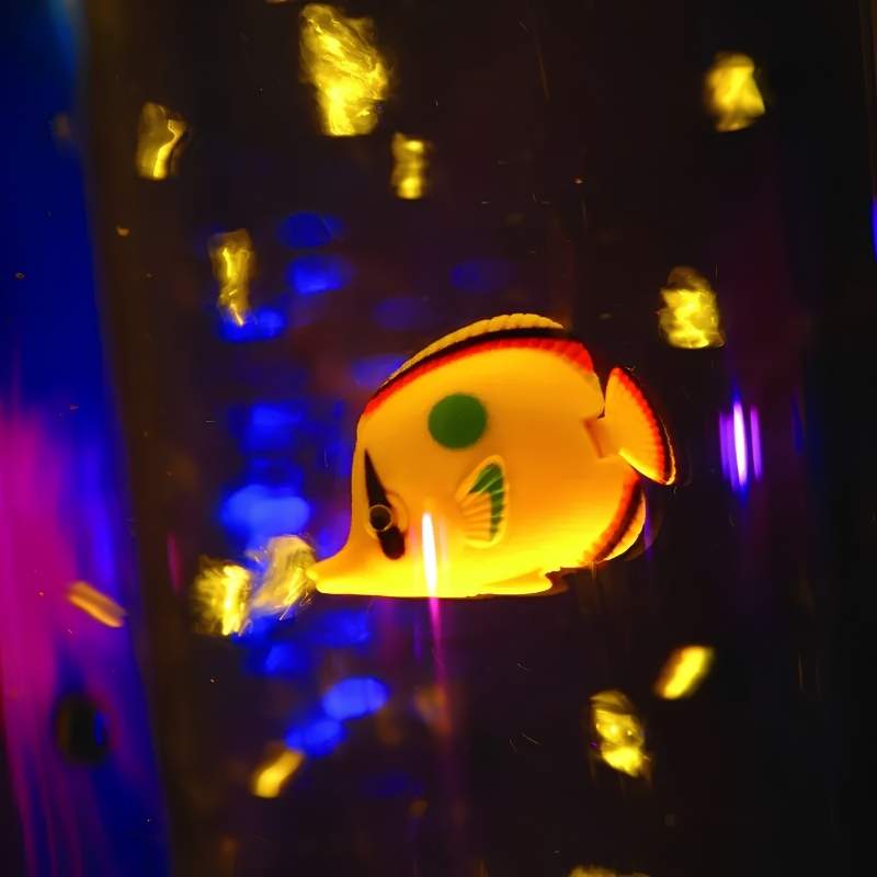 TFH Bubble Tube Fish glowing yellow butterflyfish floating inside an illuminated sensory bubble tube