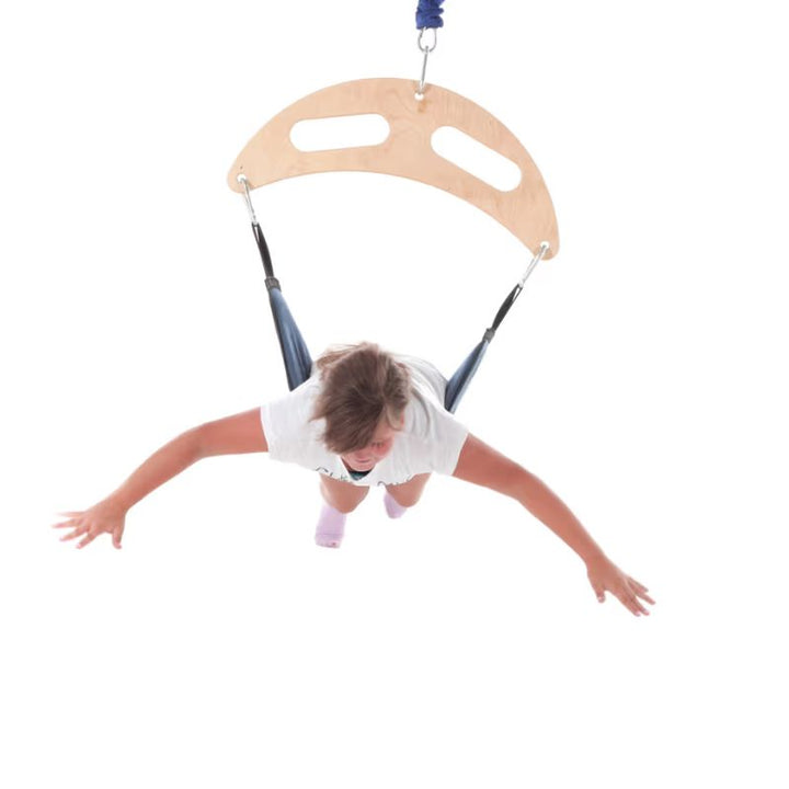 Child lying prone on the TFH Bungee Frog Swing, bouncing for vertical vestibular input during sensory play