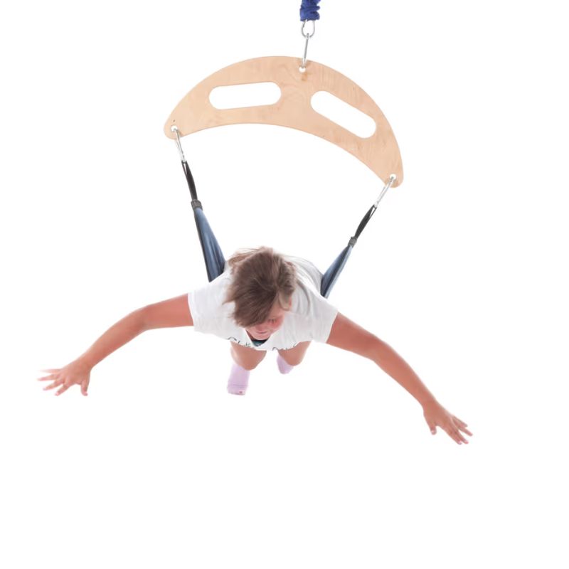Child lying prone on the TFH Bungee Frog Swing, bouncing for vertical vestibular input during sensory play