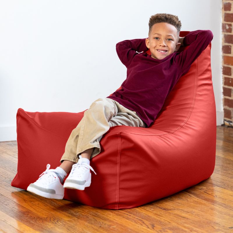 Child relaxing on the Jaxx Pezzi classroom bean bag chair in red vinyl, sensory seating for calm corners