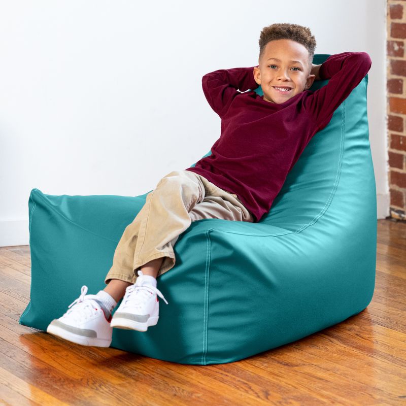 Child lounging on the Jaxx Pezzi classroom bean bag chair in turquoise vinyl, supportive seating for reading time