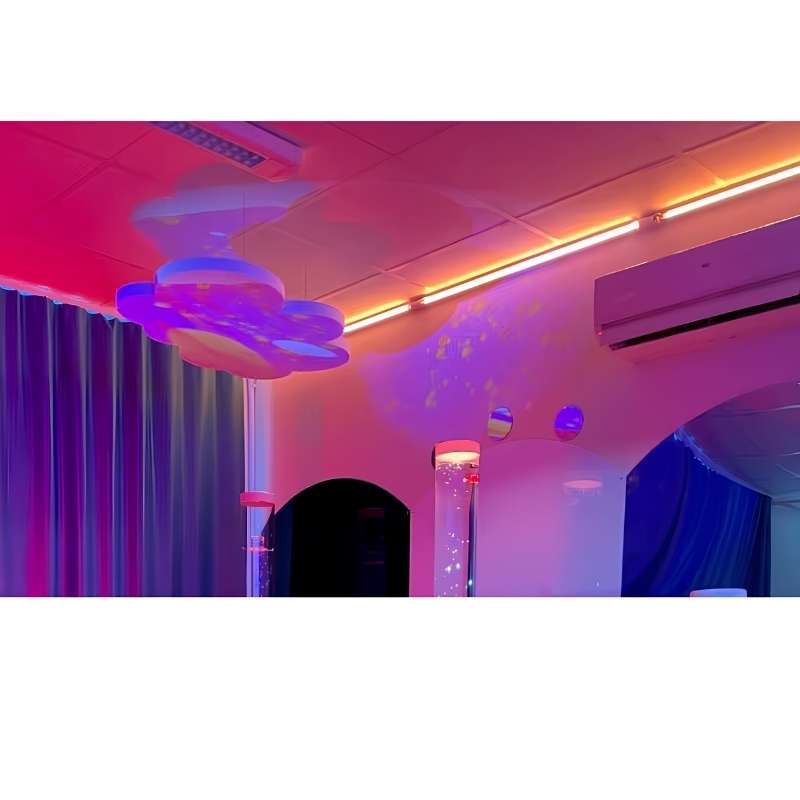 TFH Genie Colour Wash Kit ceiling-mounted LED strip casting warm orange and pink interactive sensory lighting above a bubble tube