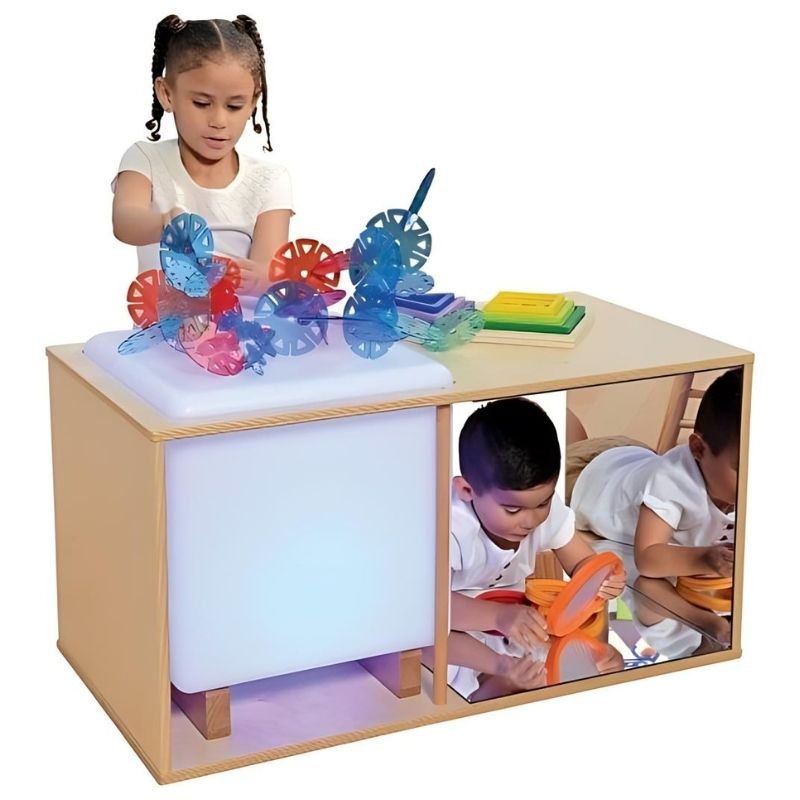 Child actively exploring the Constructive Playthings Ultimate Light Cube Studio Cabinet with 3 Mirrors, showing collaborative sensory light and reflection play in a classroom setting