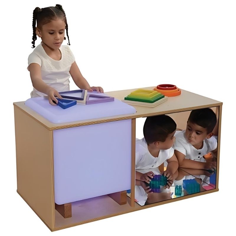 Child exploring the mirrored play space side of the Constructive Playthings Ultimate Light Studio, showing the shatterproof acrylic mirror reflection feature for visual and sensory learning