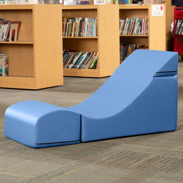 Jaxx Flexx convertible foam chair in blue vinyl staged in a classroom reading corner