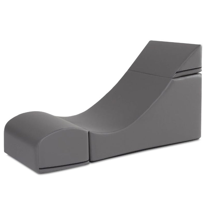 Jaxx Flexx convertible foam chair in charcoal grey vinyl shown expanded as a lounge chair, a sensory foam chair for schools