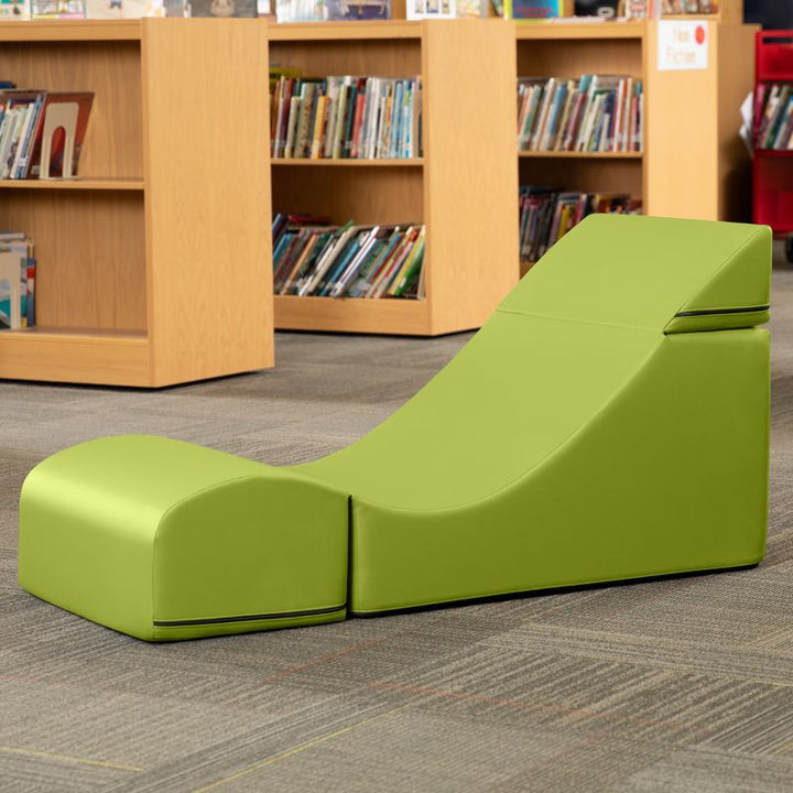 Jaxx Flexx convertible foam chair in green vinyl staged in a classroom reading corner