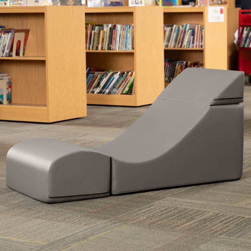 Jaxx Flexx convertible foam chair in grey vinyl staged in a school library reading corner
