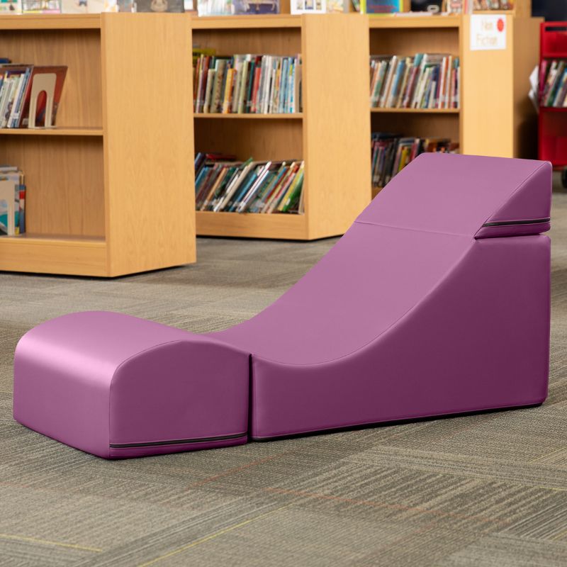 Jaxx Flexx convertible foam chair in purple vinyl staged in a school library reading corner