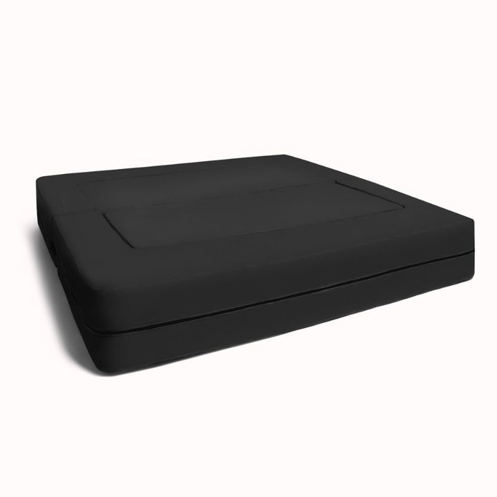 Jaxx Zipline convertible kids sofa in black, shown in its flat bed configuration with visible zip seam