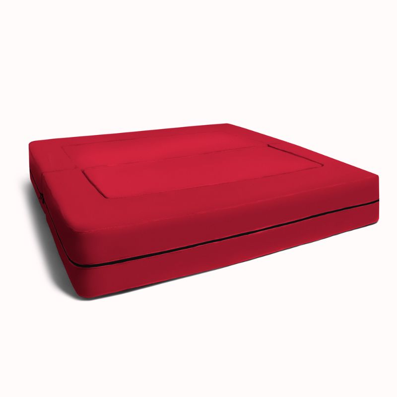 Jaxx Zipline convertible kids sofa in red, shown flattened into its bed position for lounging