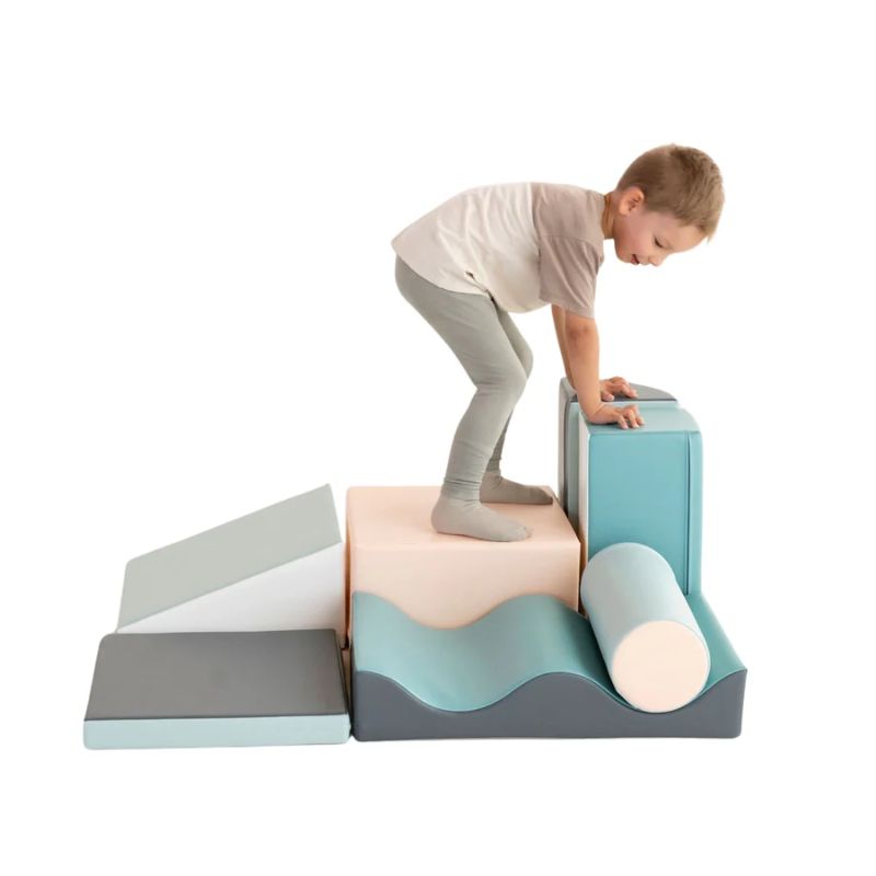 Boy climbing on the IGLU Discoverer Soft Play Set in Pastel Turquoise, supporting toddler balance and coordination