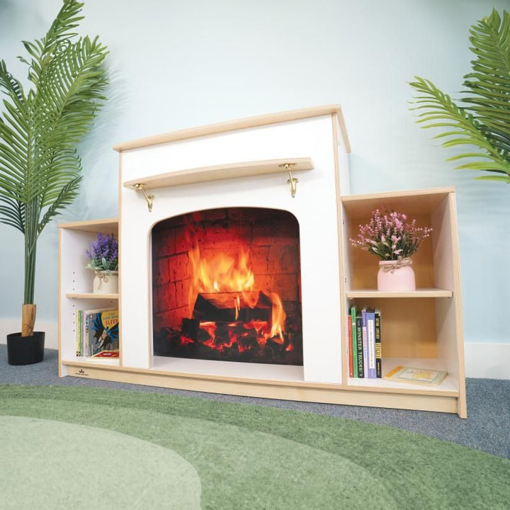 Whitney Brothers Warm and Welcoming Fireplace in white, a dramatic play fireplace with mantel and book shelves creating a cozy reading nook in a classroom
