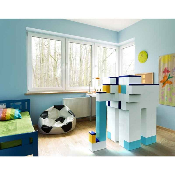 EverBlock Medium Starter Kit built into a tall tower structure in a kid's bedroom, showing giant building blocks used for imaginative play at home