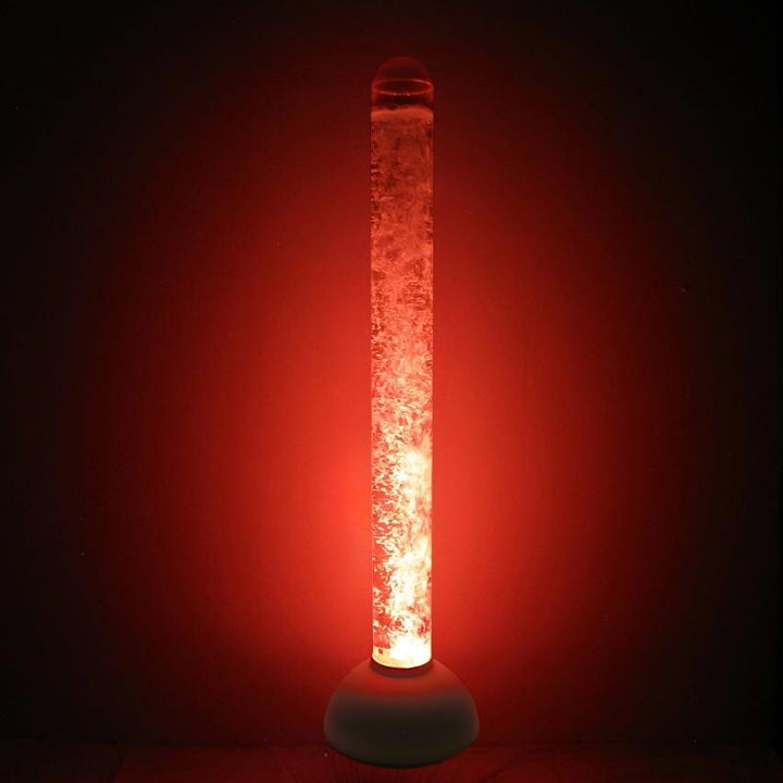 Experia Calming LED Bubble Tube landscape view glowing in red light in a dark sensory room, showing the auto colour-cycling 60-inch bubble tube with no controller required