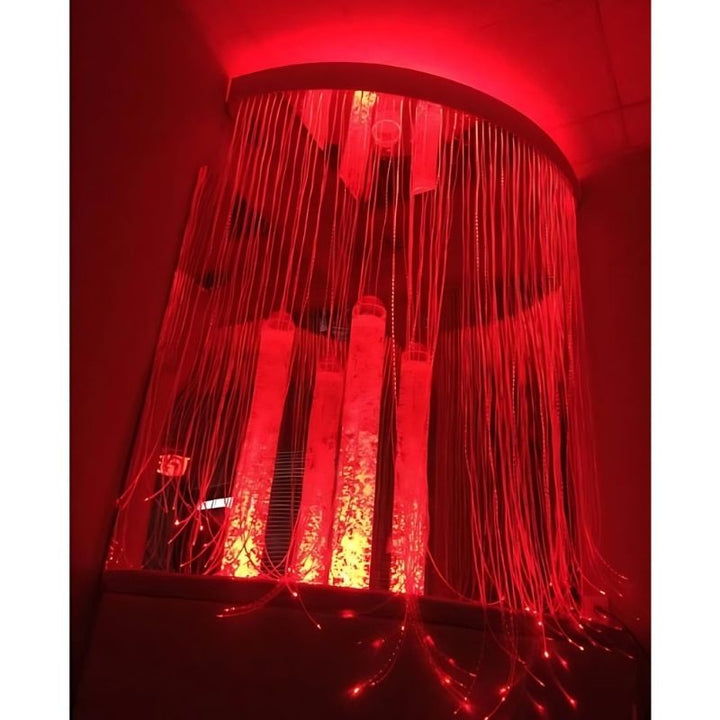 Experia Calming Sensory Cocoon corner view in red light showing the bubble tube, Calming Corner Shower, and 48-inch mirror pair creating the surround-light immersive sensory space