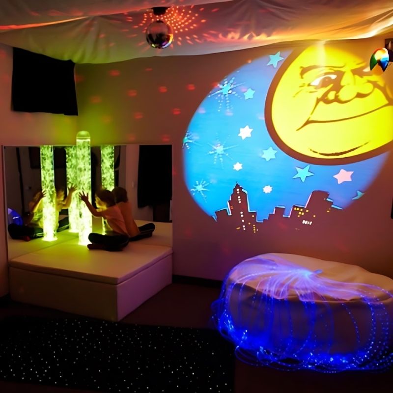 Experia Calming Sensory Room complete setup showing the calming bubble tube, platform, acrylic mirrors, Fiber Optic Star Carpet, and Softie in a fully equipped corner sensory environment