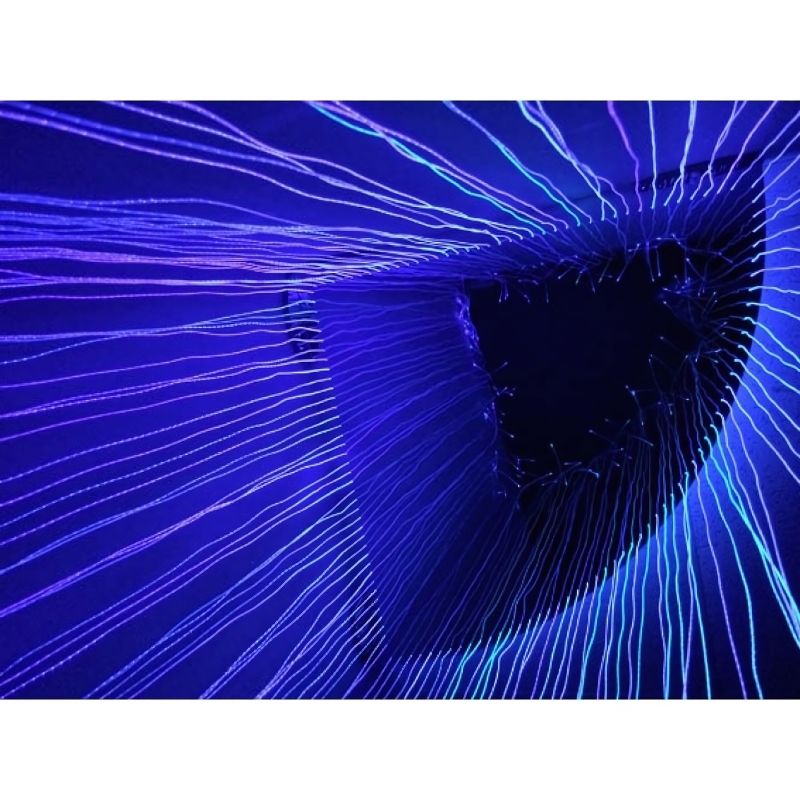 Inside view of the Experia Fibre Optic Sensory Corner Shower in purple light showing the immersive experience of being surrounded by colour-changing fibre optic strands and the acrylic mirror ceiling infinity effect