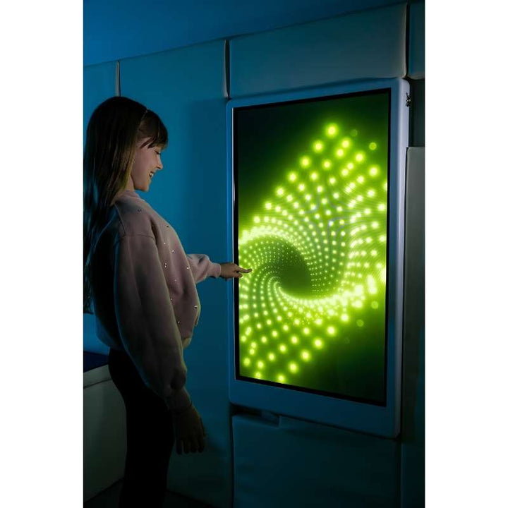 Teen engaging with the Experia Intelli Panel Infinity interactive sensory wall panel in apple green light