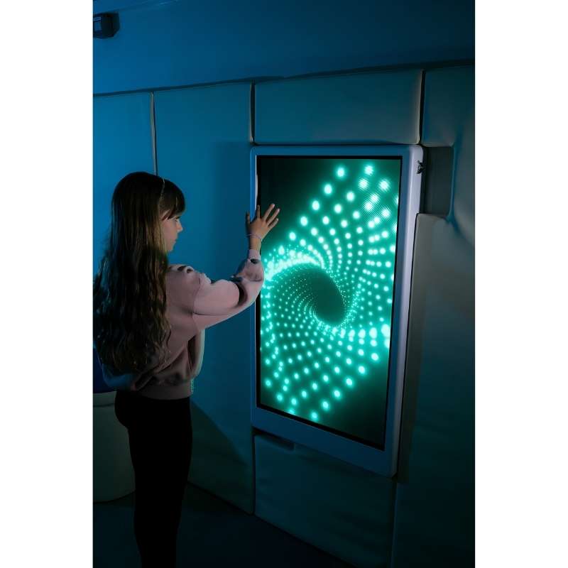 Teen engaging with the Experia Intelli Panel Infinity interactive sensory panel displaying cyan light effects