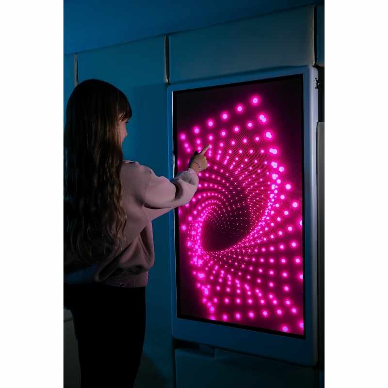 Teen engaging with the Experia Intelli Panel Infinity sensory wall panel displaying pink light effects