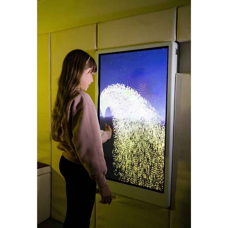 Child engaging with the Experia Intelli Panel Particle sensory wall panel in a yellow-lit room, second view