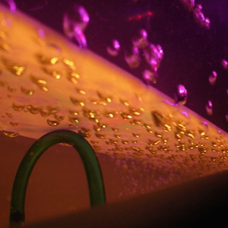 Close-up view of the Experia IRiS+ Bubble Wall with iConverter bundle, showing the LED bubble wall detail and rising bubbles for sensory room visual stimulation
