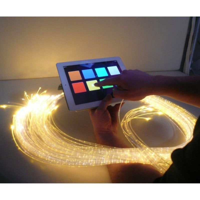 Top view of the Experia IRiS+ LED Fibre Optic Bundle with iConverter showing a user pressing the IRiS+ App on an Apple device to wirelessly control the fibre optic strands