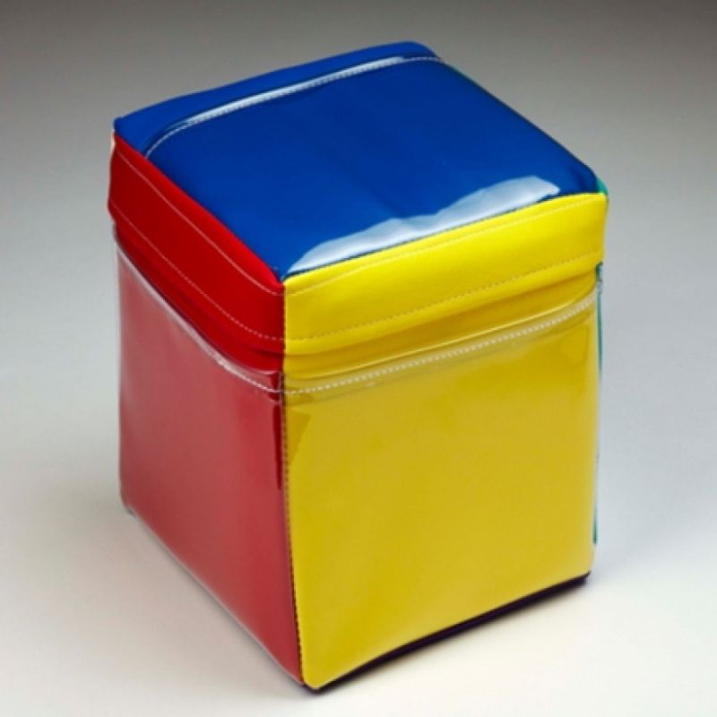 Close-up of the Experia IRiS Qube showing the soft 10-inch cube with 6 differently coloured sides and clear vinyl pockets — the roll-to-colour IRiS Talker for controlling all paired IRiS Listeners