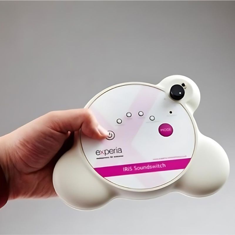 Close-up of the Experia IRiS Soundswitch wireless Talker held in hand, showing voice-activated control of the IRiS Sensory Room for vocalization and communication development