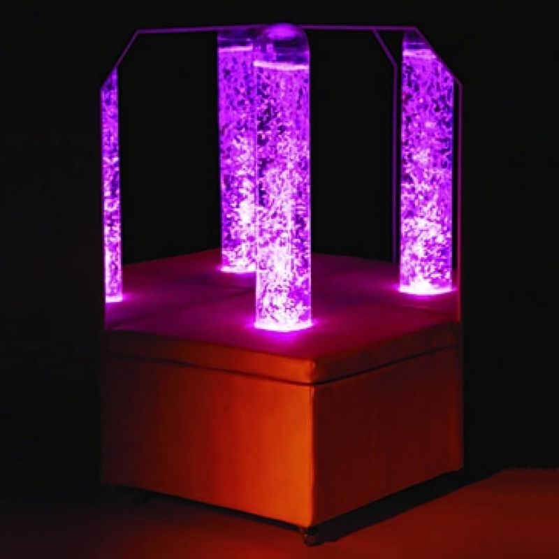 Experia Portable Bubble Tube Corner in purple light showing the wheeled LED bubble tube platform with acrylic mirrors in a dark room, demonstrating the mobile sensory bubble tube for home and clinical settings