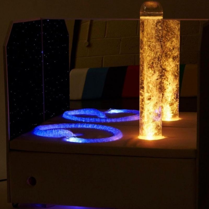 Experia Portable Sensory Corner Calming with orange LED bubble tube and blue-purple fibre optic strands glowing, demonstrating the colour-cycling calming sensory light effect