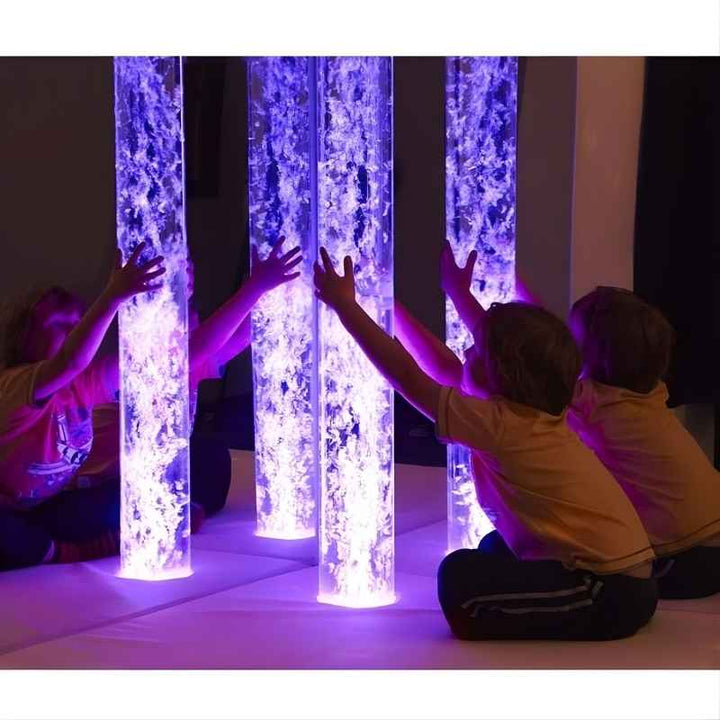 Child engaging with the Experia Premium Sensory Room beside the acrylic mirror pair, showing the immersive multi-sensory environment in a school or therapy room setting